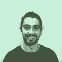 Curly hair man with a bun. Profile picture of Javier.